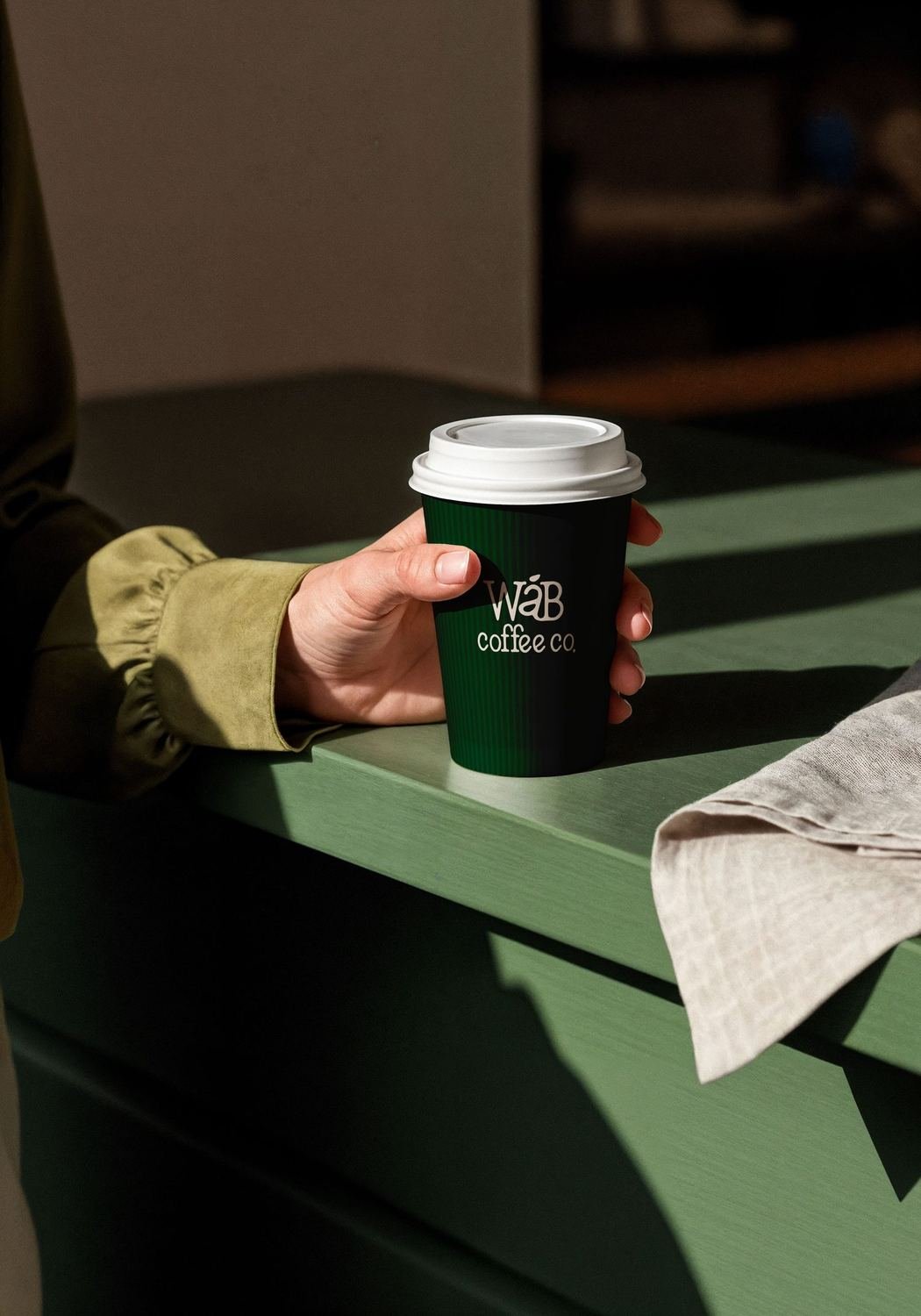 A WÁB cup in hand